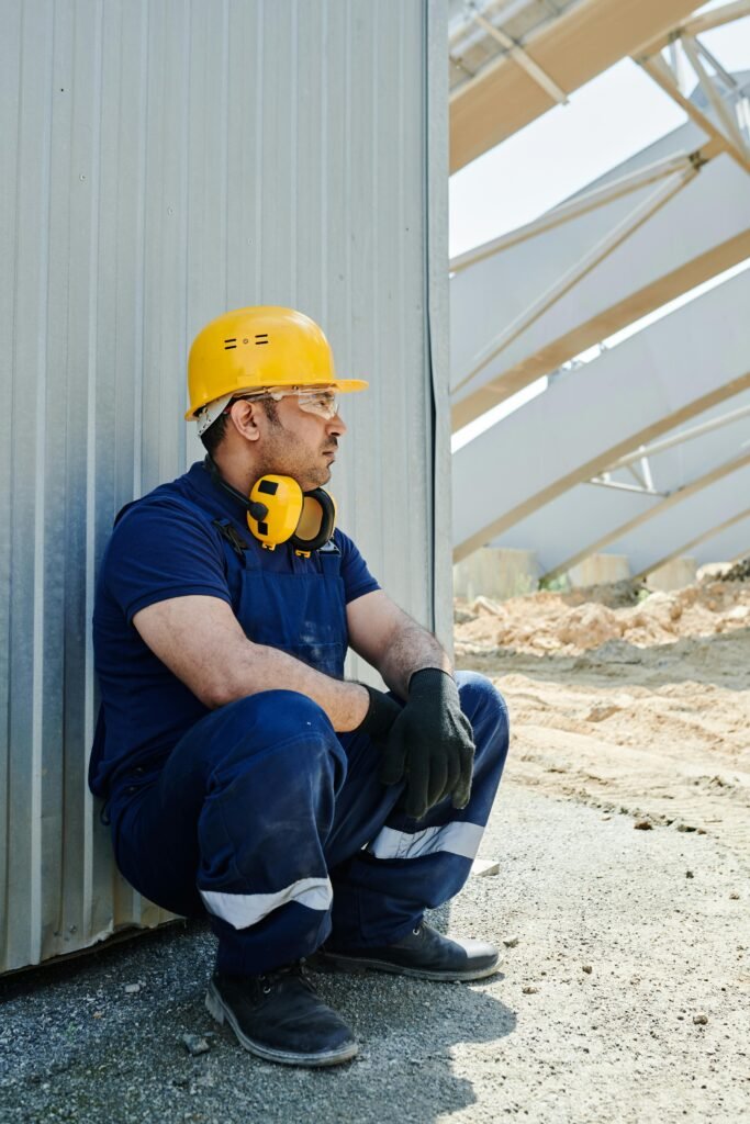 Worker in safety gear experiencing heat stress.